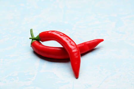 Hot chili peppers on blue backgroundの写真素材