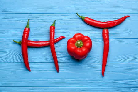 Word HOT made of peppers on blue wooden backgroundの写真素材