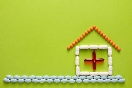 Creative composition with pills and capsules on green backgroundの写真素材
