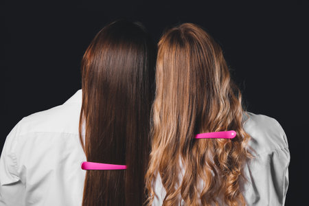 Women with beautiful long hair and hair pins on dark backgroundの写真素材