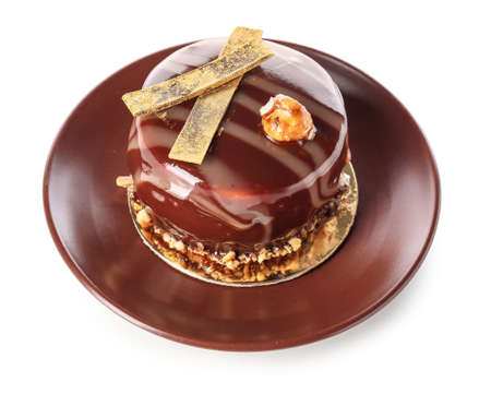 Plate with delicious chocolate cake on white backgroundの写真素材