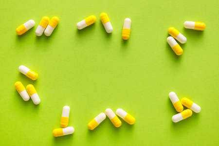 Many capsules on green background
