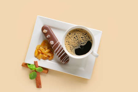 Plate with delicious chocolate cake and cup of coffee on light background