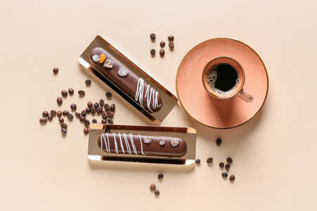Delicious chocolate cakes and cup of coffee on light background