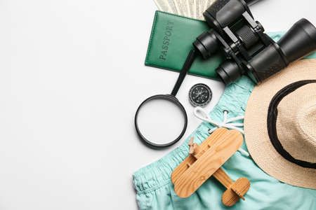 Composition with travel items, passport and wooden plane on white backgroundの写真素材