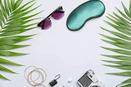 Frame made of beach accessories and palm leaves on white backgroundの写真素材