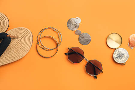 Set of beach accessories with compass on color backgroundの写真素材