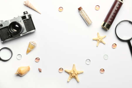 Frame made of travel items, starfishes and seashells on white background