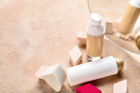 Different makeup sponges and foundation on color background, closeupの写真素材