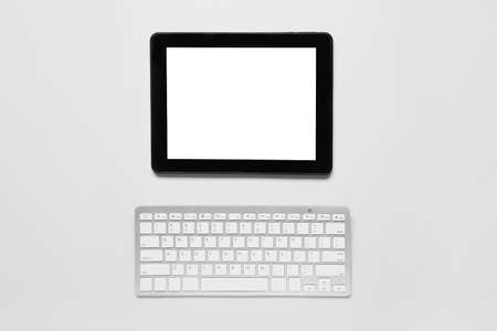 Modern tablet computer and keyboard on white backgroundの写真素材