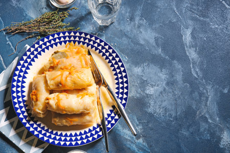 Plate with tasty stuffed cabbage rolls on color backgroundの写真素材