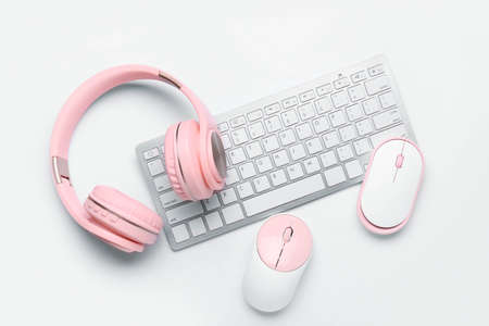 Modern headphones, keyboard and PC mouses on white backgroundの写真素材