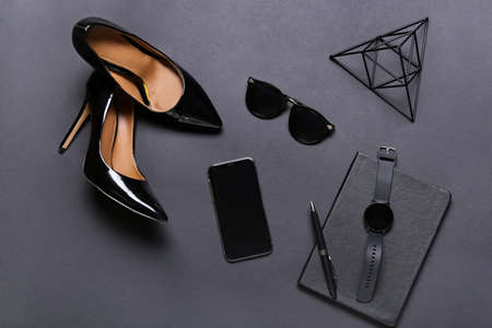 Composition with mobile phone, smart watch and female accessories on dark backgroundの写真素材