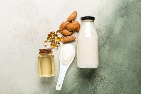 Composition with bottle of essential oil, pills and products on color backgroundの写真素材