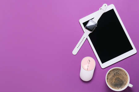 Tablet computer, smart watch, PC mouse and cup of coffee on color background