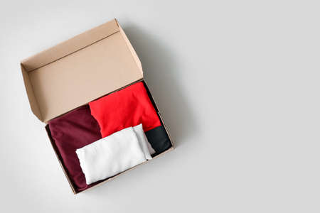 Wardrobe box with clothes on light backgroundの写真素材