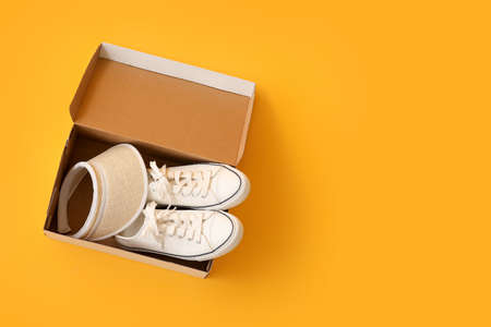 Wardrobe box with shoes and cap on color backgroundの写真素材