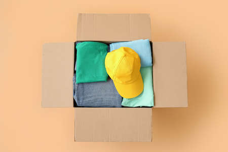 Wardrobe box with clothes on color backgroundの写真素材