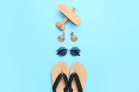 Composition with beach accessories and wooden plane on color backgroundの写真素材