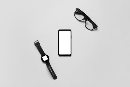 Mobile phone, smart watch and eyeglasses on white background