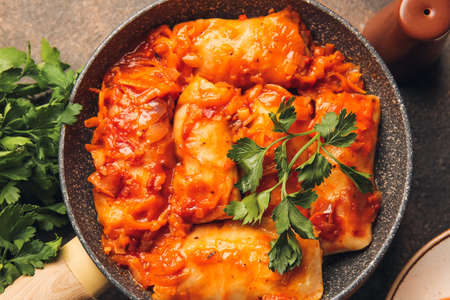 Frying pan with tasty stuffed cabbage rolls on dark backgroundの写真素材