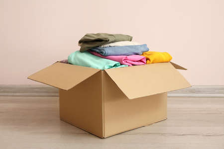 Wardrobe box with clothes near color wallの写真素材