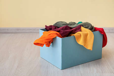 Wardrobe box with clothes near color wallの写真素材