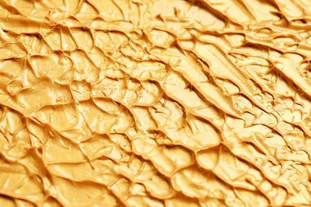 Texture of rough golden paint, closeup viewの写真素材