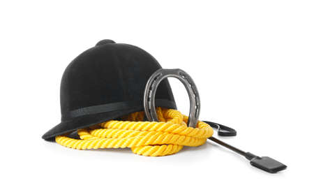 Horse riding helmet and crop with rope and horseshoe on white background