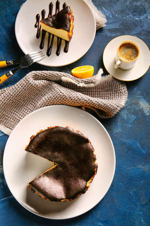 Tasty Basque burnt cheesecake with coffee on color background