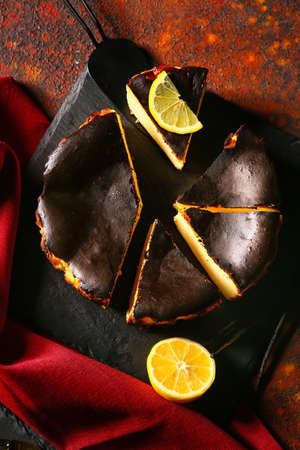 Tasty Basque burnt cheesecake on color background
