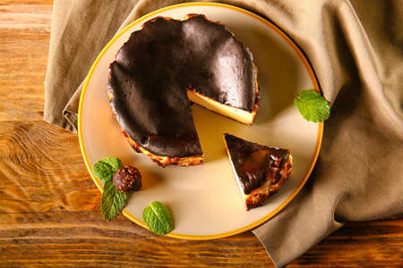 Plate with tasty Basque burnt cheesecake on tableの写真素材