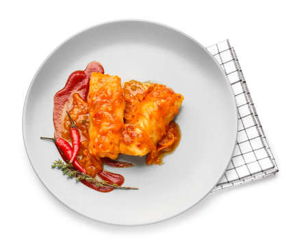 Plate with tasty stuffed cabbage rolls on white background