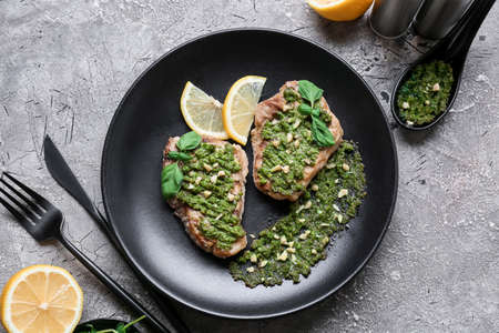 Composition with tasty steaks and sauce pesto on grunge backgroundの写真素材