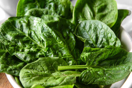 Bowl with fresh spinach leaves, closeupの写真素材