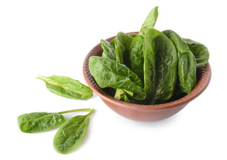 Bowl with fresh spinach leaves on white backgroundの写真素材