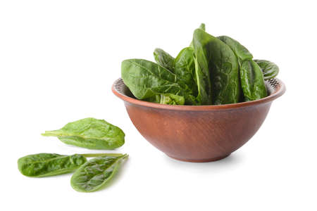 Bowl with fresh spinach leaves on white backgroundの写真素材