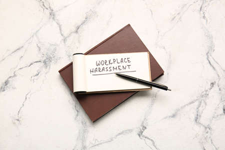 Notebooks with text WORKPLACE HARASSMENT on light backgroundの写真素材