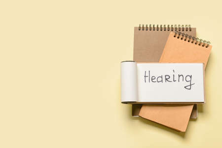 Notebooks with word HEARING on color backgroundの写真素材