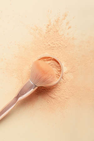 Makeup brush and loose powder on light backgroundの写真素材