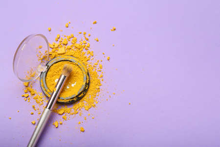 Makeup brush and eye shadow palette on color backgroundの写真素材
