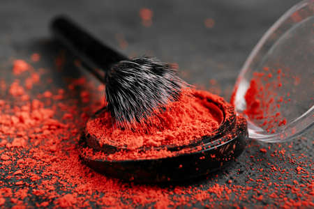 Makeup brush and eye shadow palette on grunge background