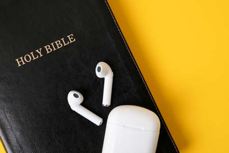 Holy Bible and earphones on color background, closeupの写真素材