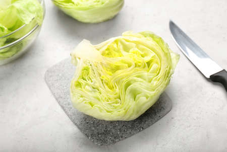 Bowl with iceberg lettuce on light background, closeupの写真素材