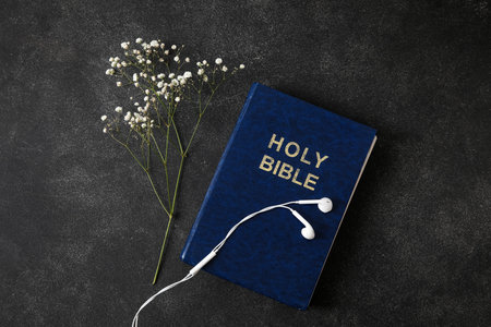 Holy Bible, gypsophila flowers and earphones on dark backgroundの写真素材