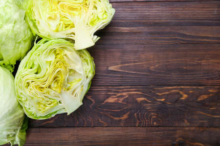 Iceberg lettuce on wooden backgroundの写真素材