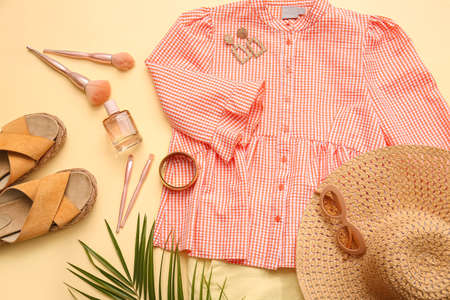 Female clothes and accessories on color background