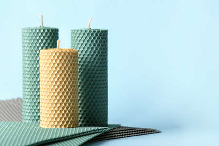 Handmade wax candles on color backgroundの写真素材