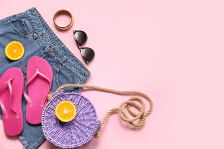 Set of beach accessories and skirt on color background, closeup