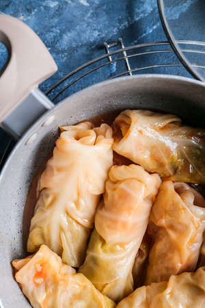 Pot with tasty stuffed cabbage rolls on color background, closeupの写真素材